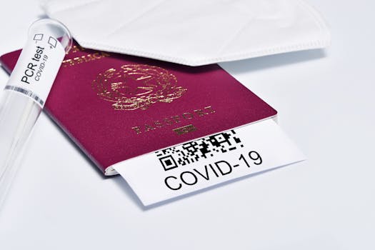 Close-up of a passport with COVID-19 test tube and face mask representing travel protocols.