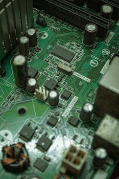 Detailed view of electronic components on a green circuit board surface.