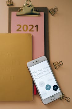 Stylish office setup featuring a 2021 calendar, smartphone, and stationery on a desk.