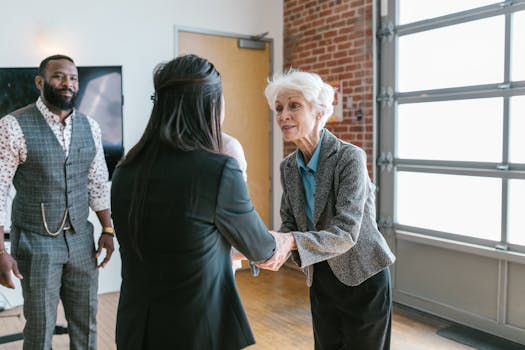 Three entrepreneurs meeting and shaking hands in a modern office setting.