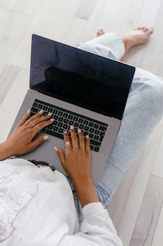 Woman working on a laptop in a relaxed setting, representing remote work.